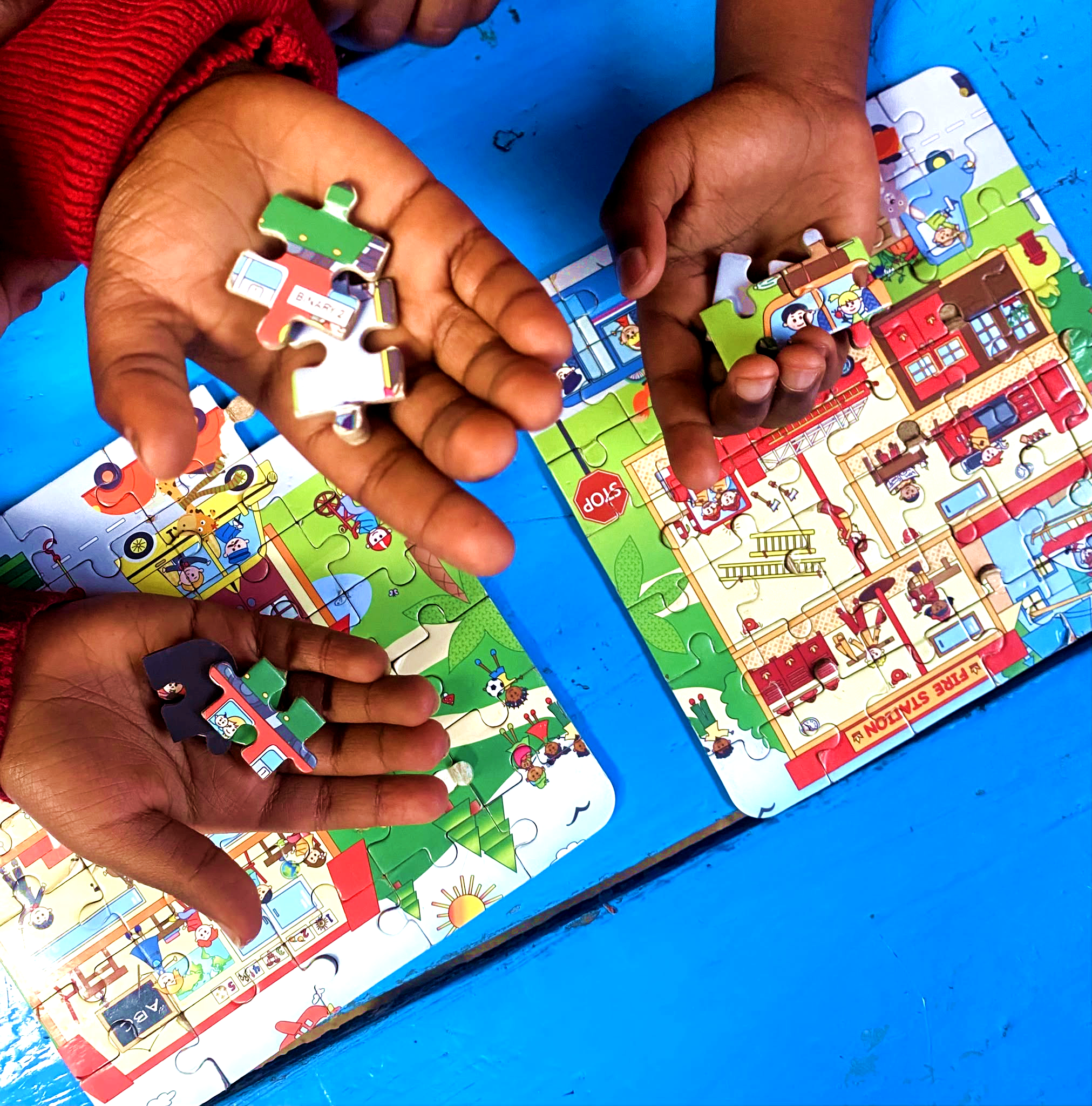 Hands working on a puzzle