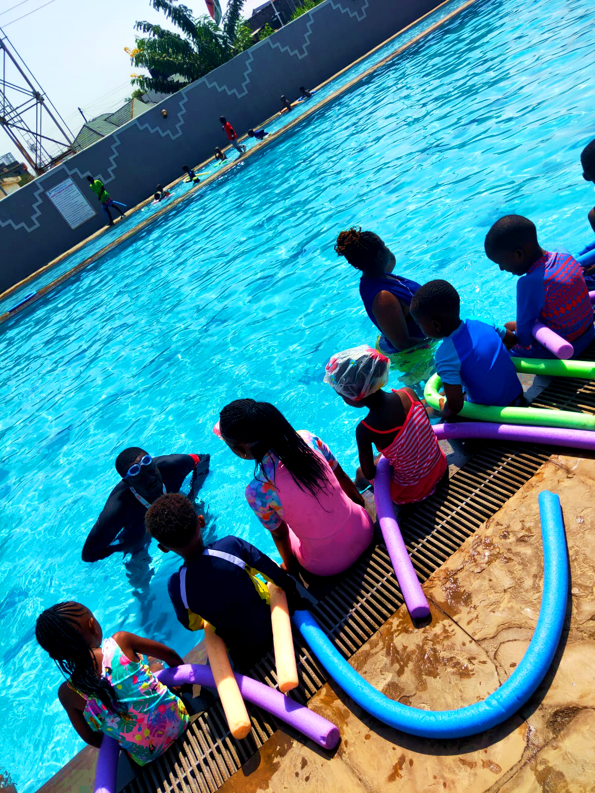 Swimming training session with pool noodles
